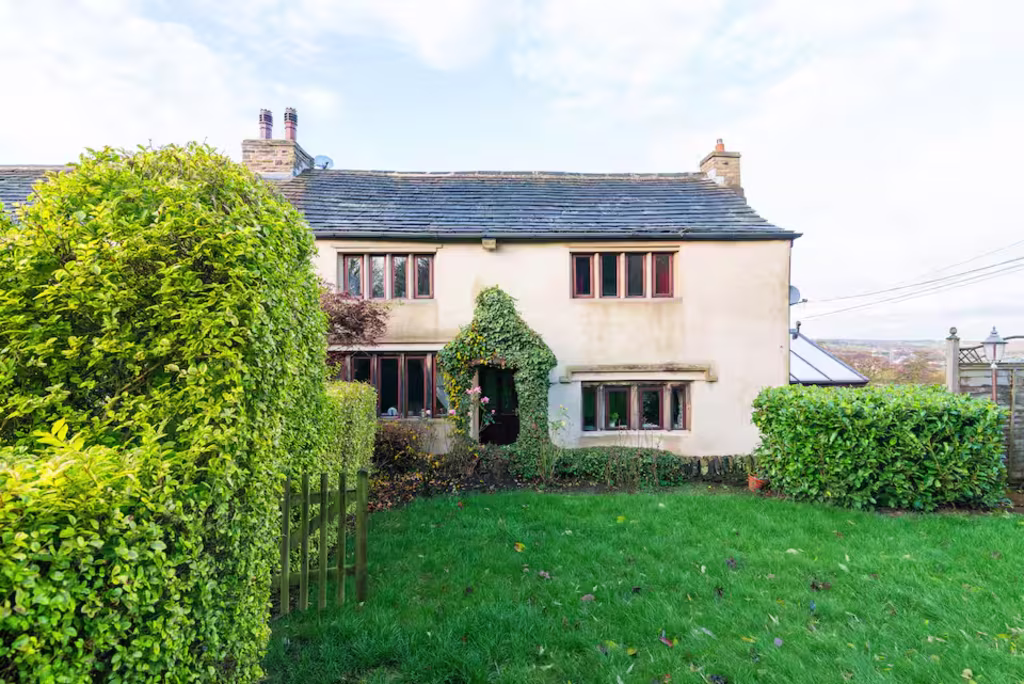 old farmhouse covered in moss and ivy